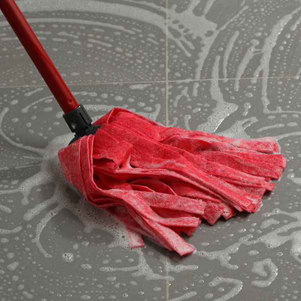 Mopping the floor tiles | Dehart Tile
