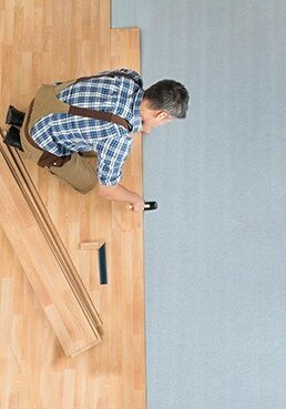 Worker Assembling New Laminate Floor | Dehart Tile